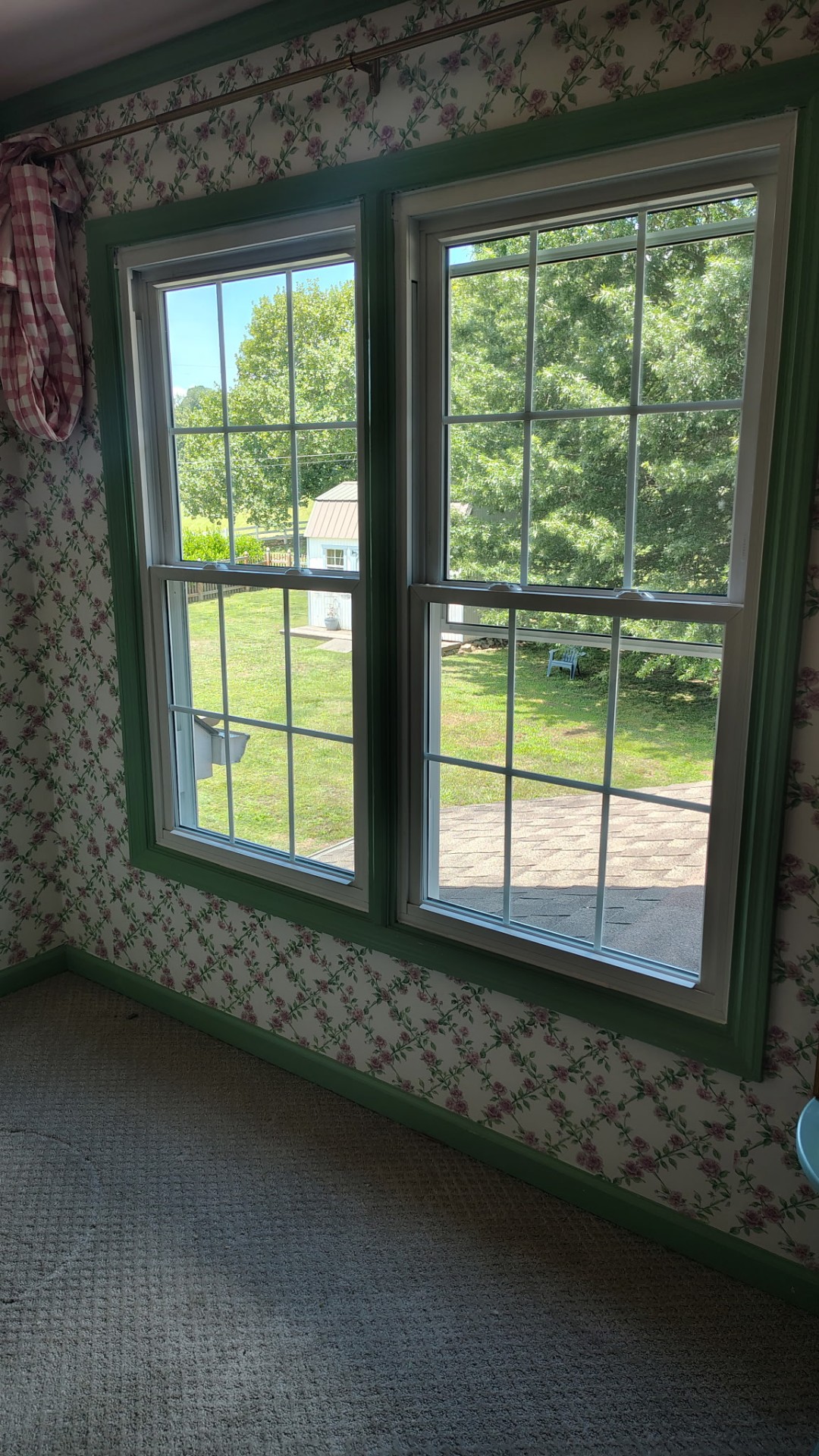 Double-hung windows with green trim